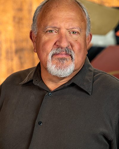 Photograph of Michael Lowery showing his face, head, and shoulders with the background from inside the lobby of Timnath Town Hall.