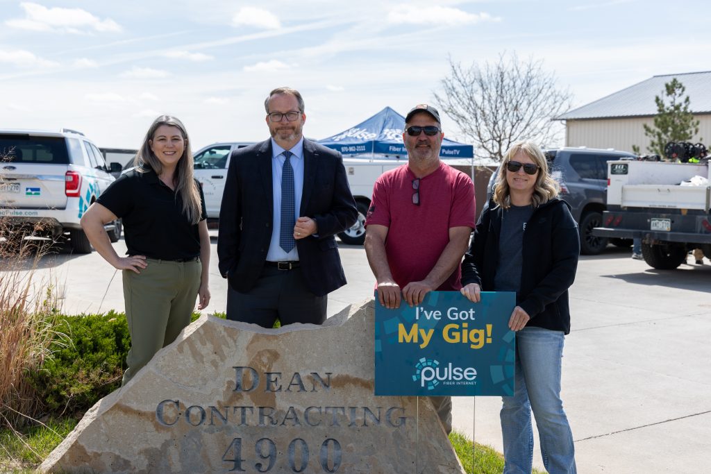 People standing around a Pulse sign. Brieana Reed-Harmel - Pulse Broadband Manager; Robert Axmacher - Mayor of Timnath; Cole Dean - Owner, Dean Contracting; Lisa Dean – Owner, Dean Contracting