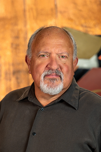 Photograph of Michael Lowry showing his face, head, and shoulders with the background from inside the lobby of Timnath Town Hall.